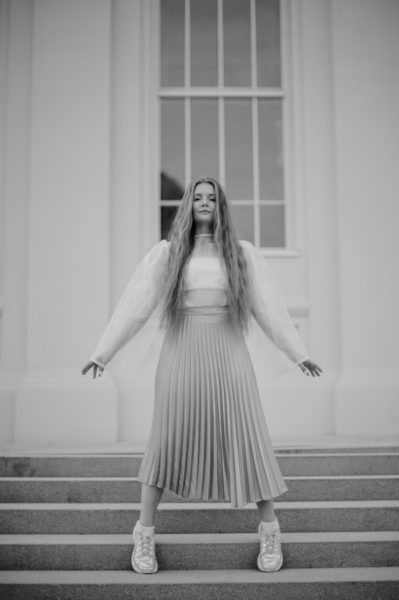 Adult Woman with Long Blond Hair Standing Tiptoes on Stairs