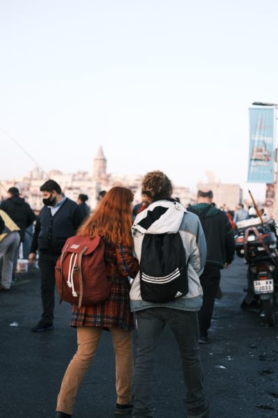 women with backpacks on street