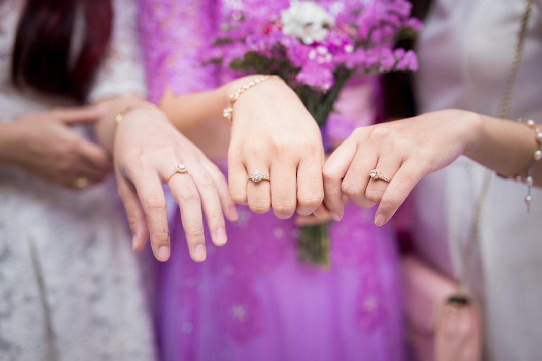 three women showing solitaire rings