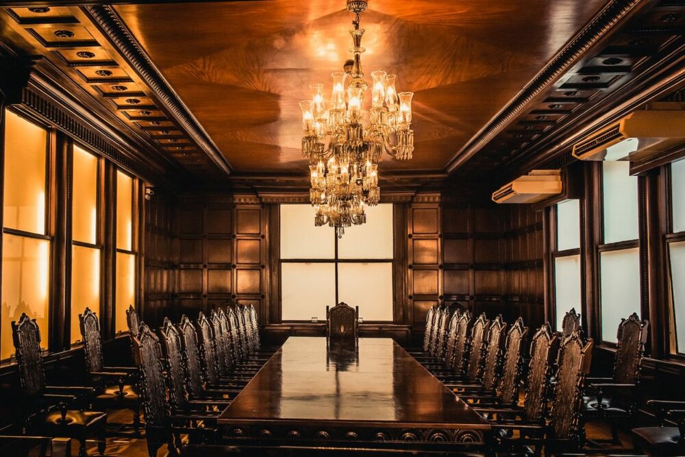 brown wooden table and chairs inside building