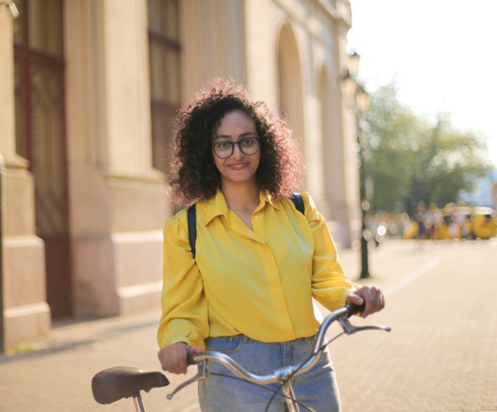 woman standing beside her bicycle
