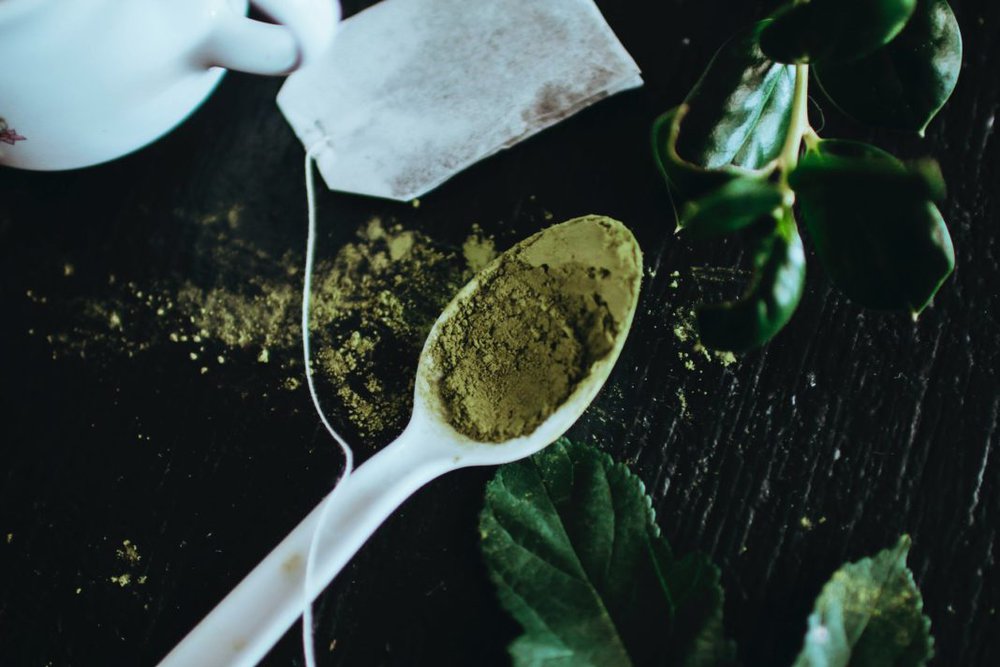 green powder on white spoon