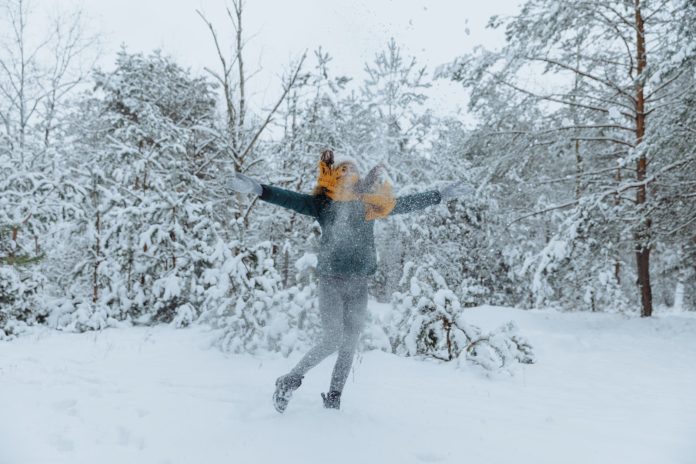 woman playing with snow