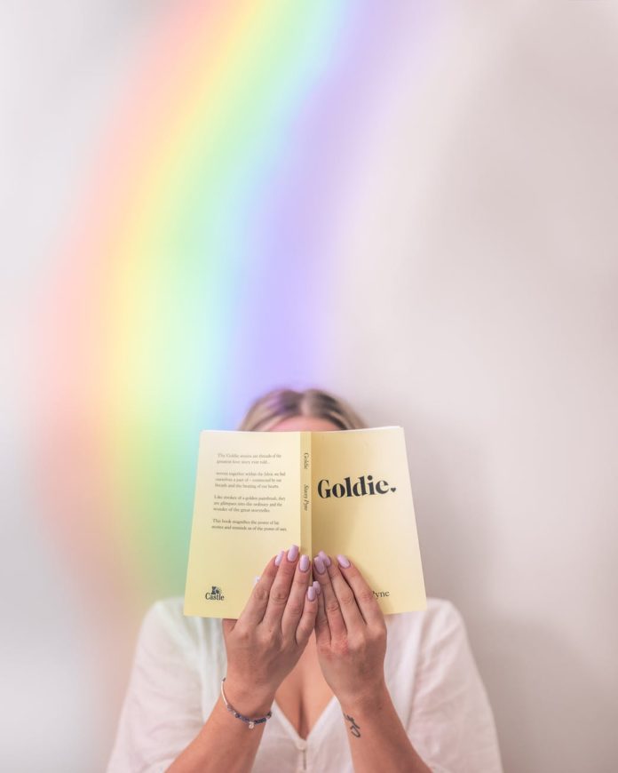woman hidden face behind opened book