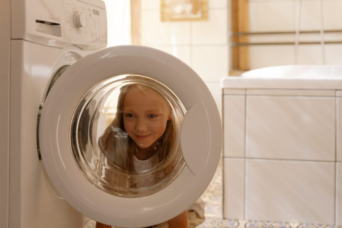 girl helping in doing the laundry