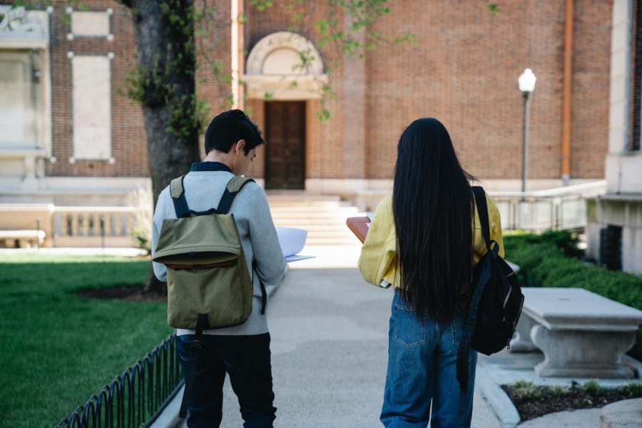 man and woman walking on pavement